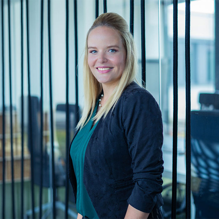 HR expert smiles in front of meeting room